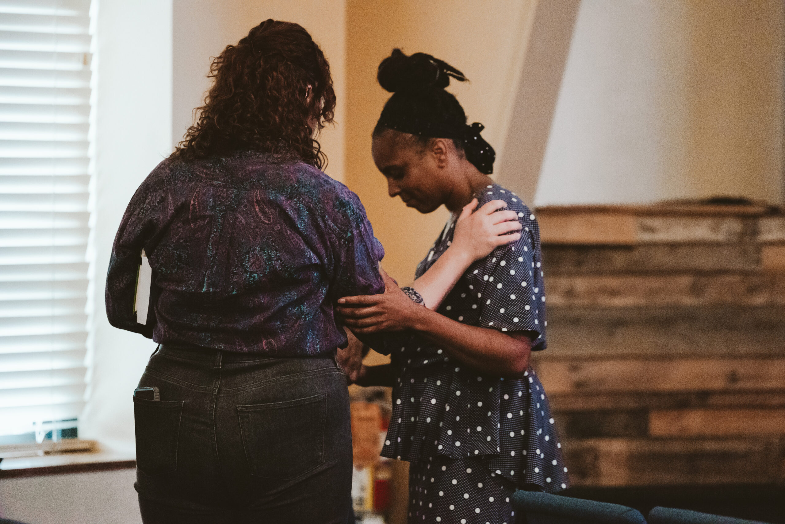 An image of woman praying at North Way Robinson