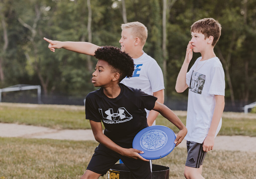 Student boys playing frisbee